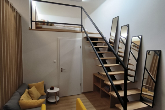Completed mezzanine living room with the renovated internal staircase